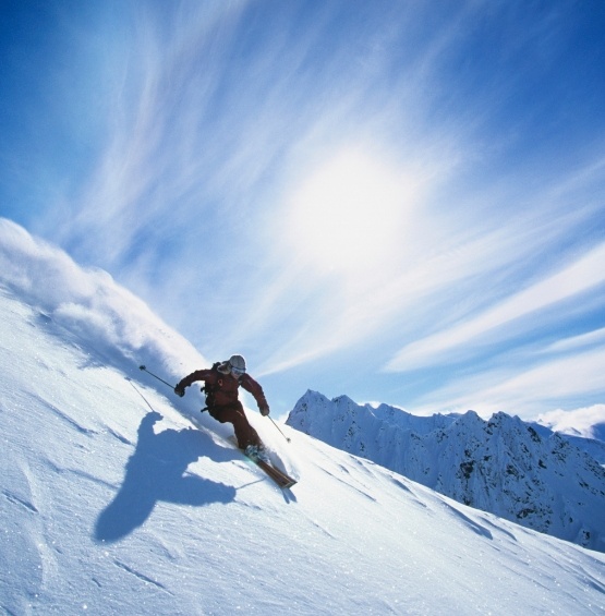 Person skiing down a snowy mountain