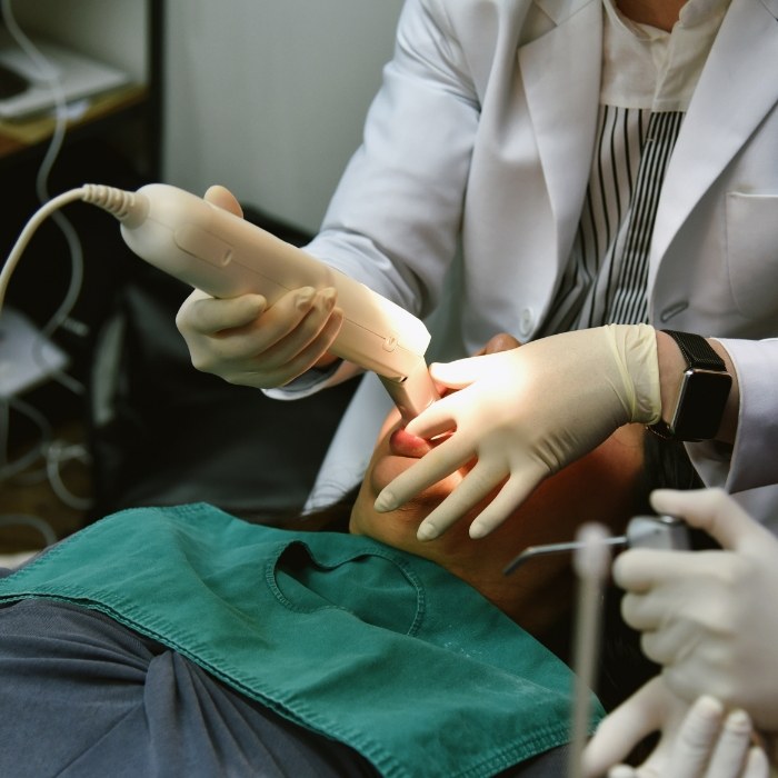 Dentist capturing digital impressions of teeth