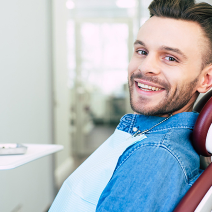 Patient smiling while sitting in treatment chair