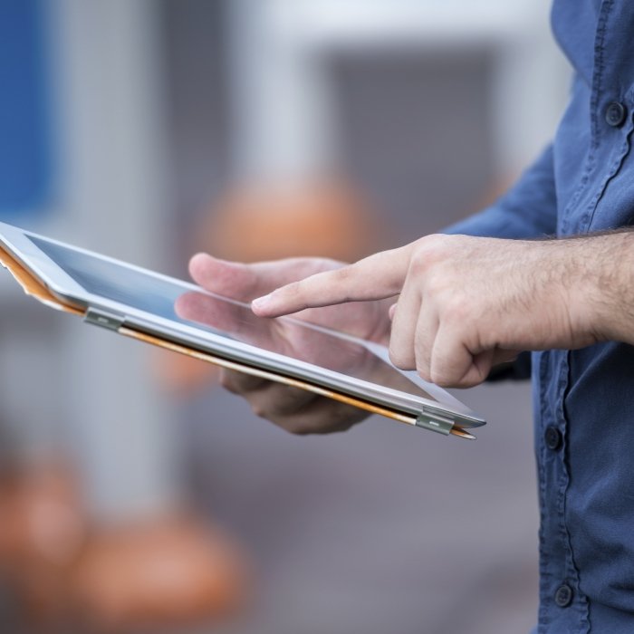 Dental team member scrolling on a tablet