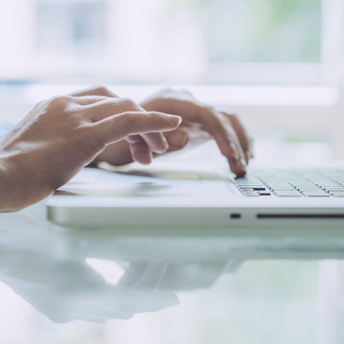 Person typing on laptop