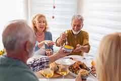 Friends enjoying a hearty meal in their kitchen