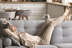 a woman laying down for a nap on her couch