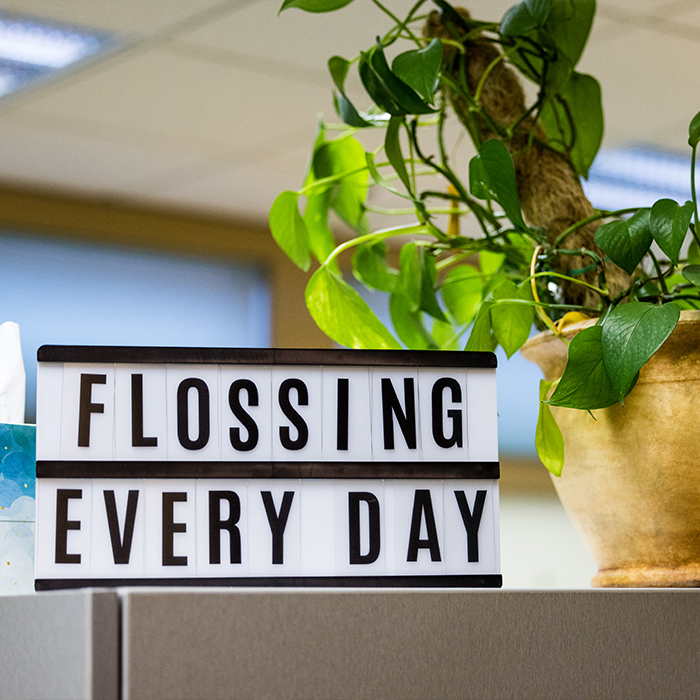 Sign on desk that reads flossing every day