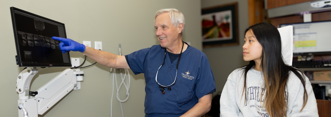 Doctor Gerner showing dental x rays to a patient