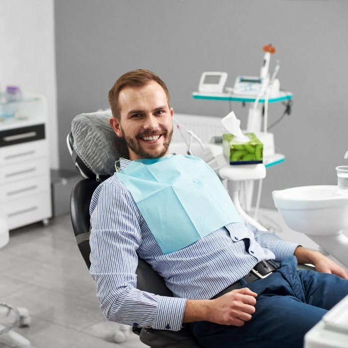 Man in dental chair smiling during preventive dentistry visit