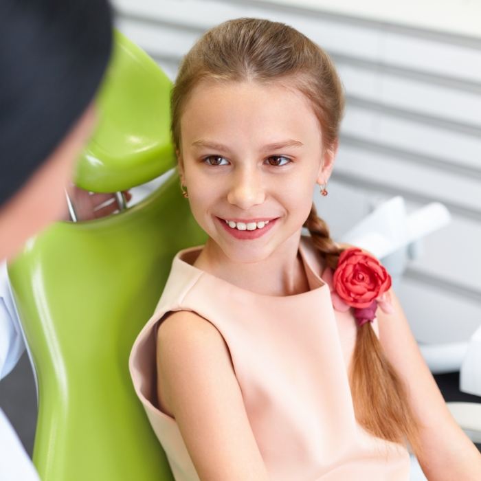 Young girl smiling at her dentist