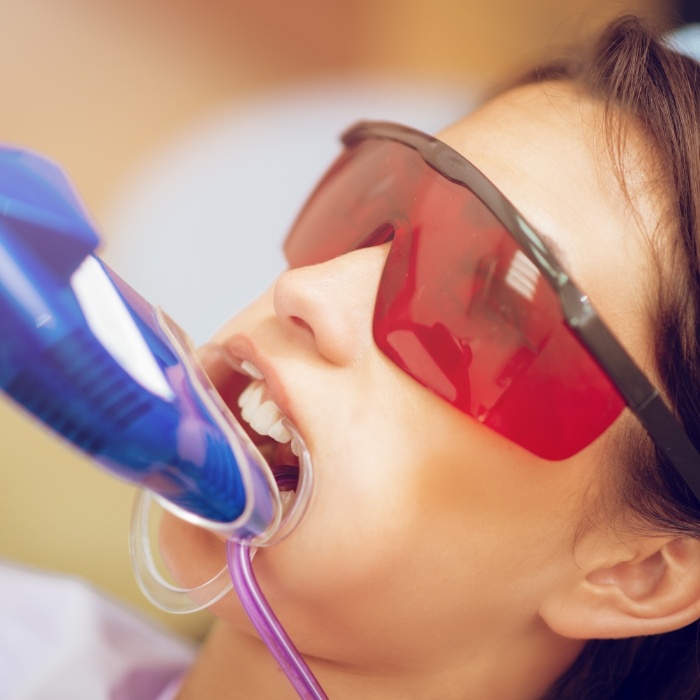 Dental patient with fluoride trays on their teeth